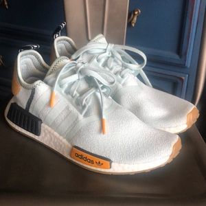 Light blue Adidas NMDs.